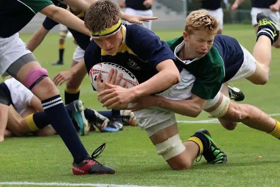 Youths playing Rugby sevens on a field