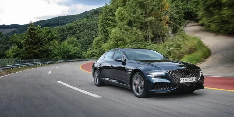 a black car driving down a winding road