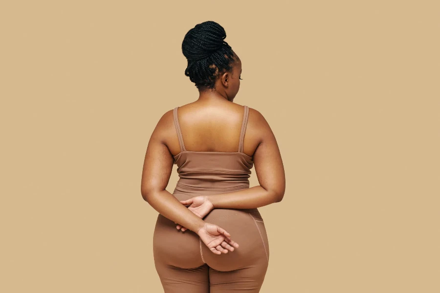 A close up of a curvaceous woman in a bodysuit