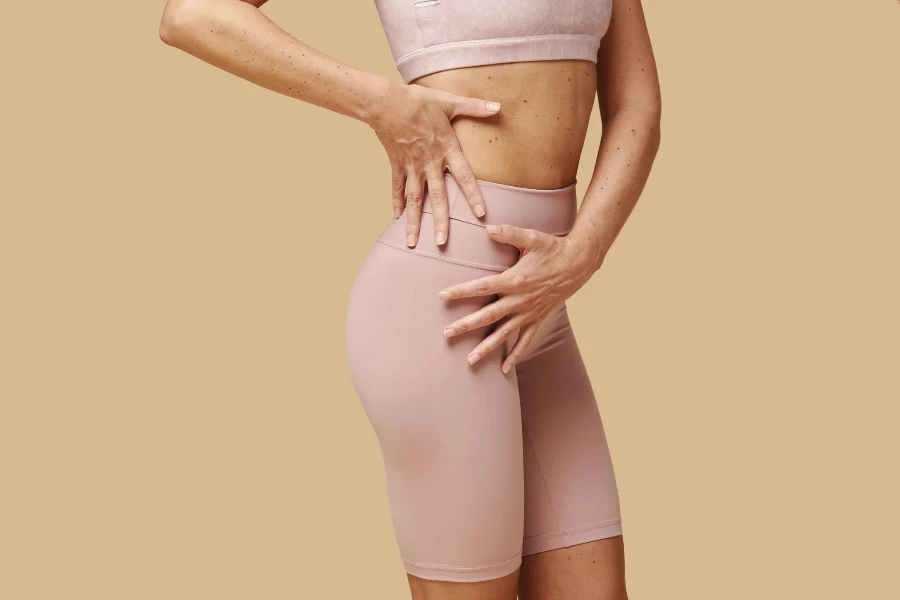 A close up of a woman wearing thigh toning shorts