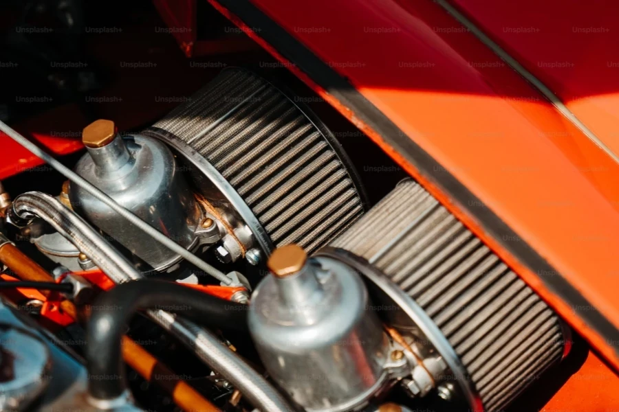 a close up of the engine of an orange sports car