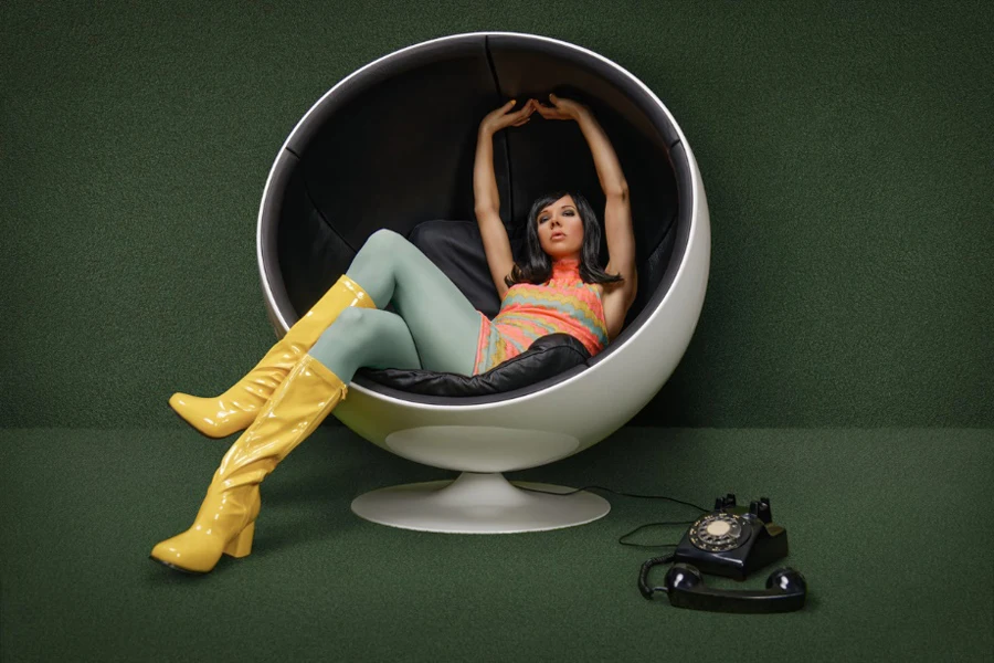 a lady sitting in a ball chair