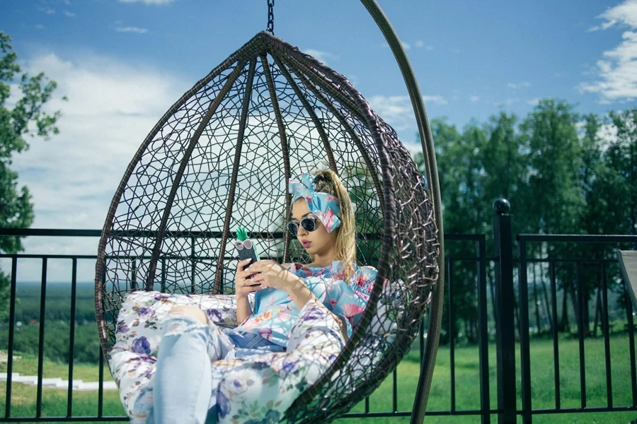 a lady sitting in an egg chair