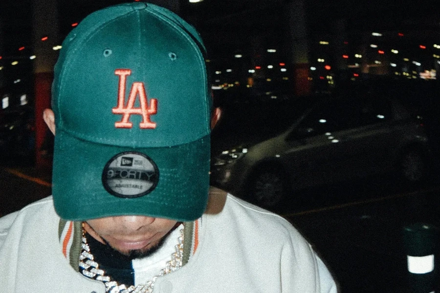 A man in a green L.A. trucker hat