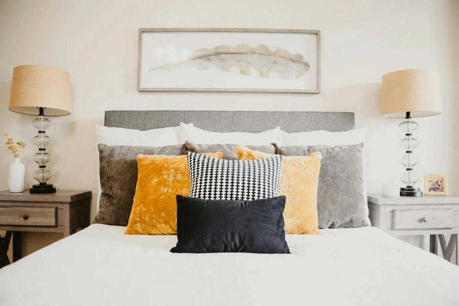 A variety of throw pillows arranged on a bed