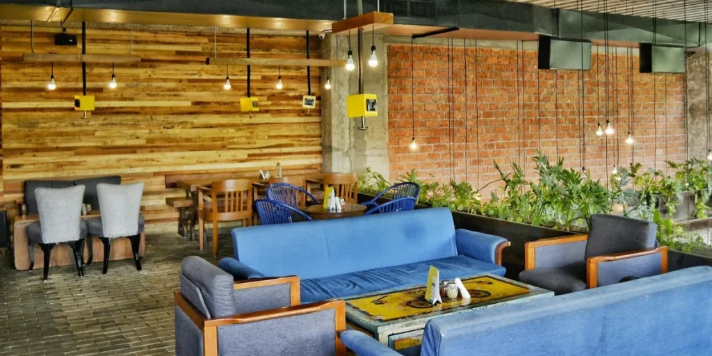 blue sofas and wooden chairs in aesthetic lounge area