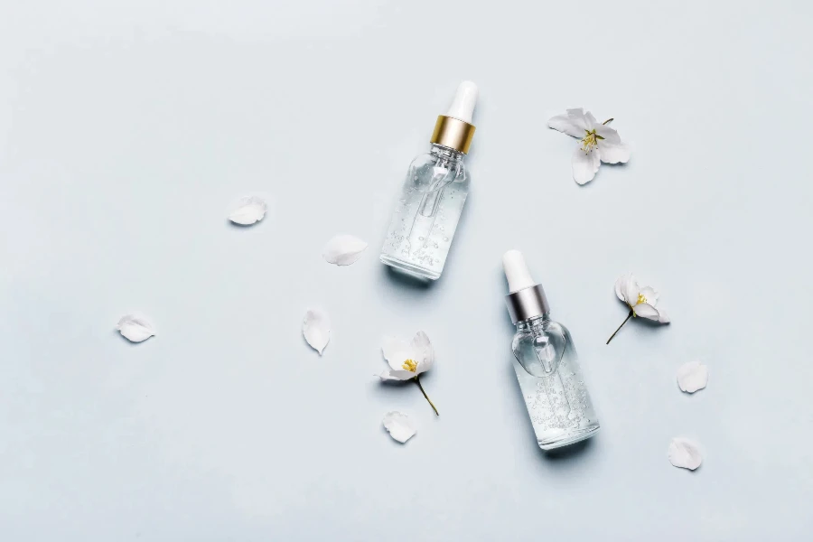 Bottles of hyaluronic acid with flowers