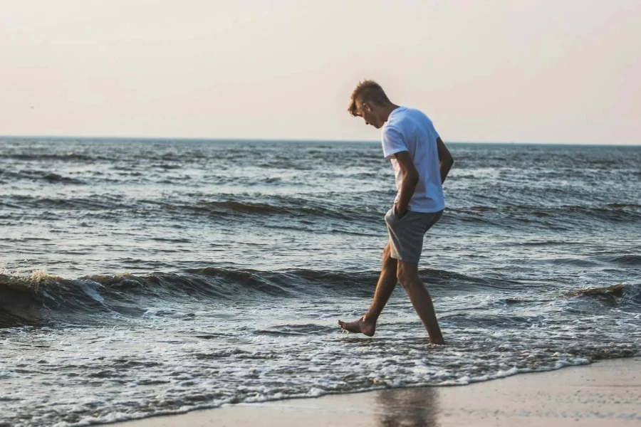 boy wearing Bermuda shorts at the beach