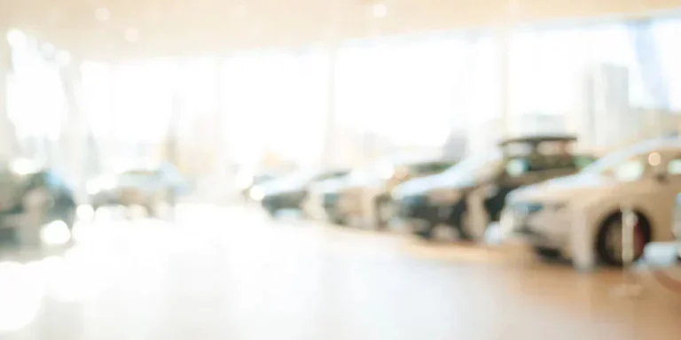 bstract background of blurred new cars dealership place