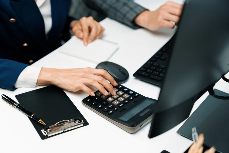 businessman with a coworker using a calculator