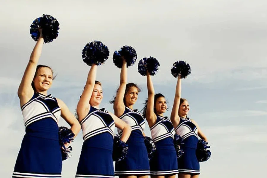 Female cheerleaders doing routine at professional football game