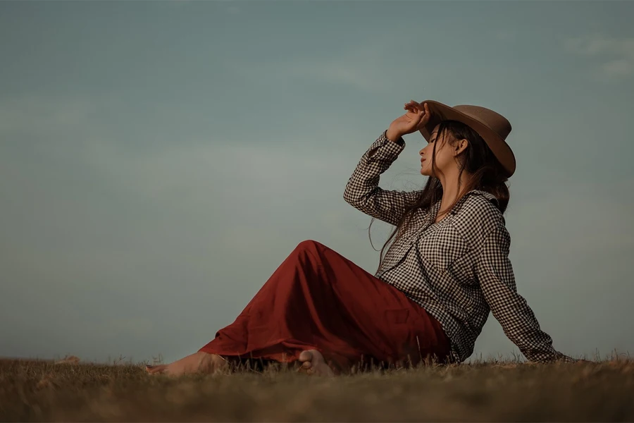 girl in a field wearing a cowboy hat