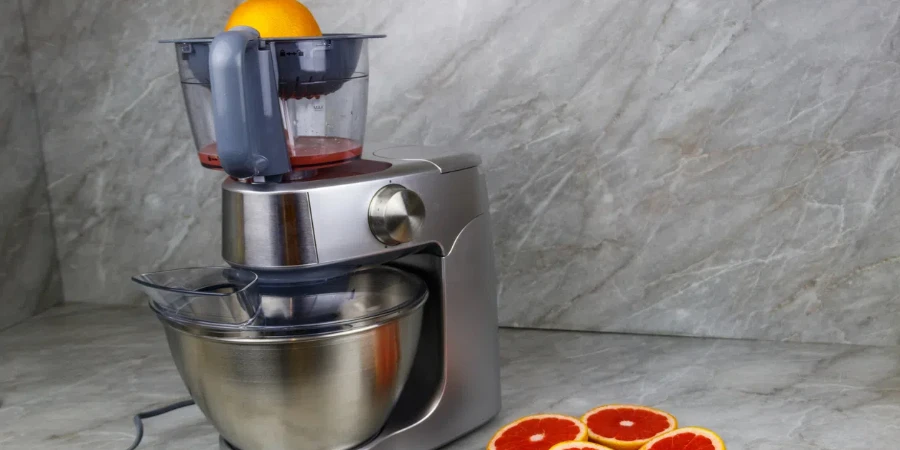 modern electric juicer and grapefruits on a kitchen table