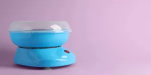 candy cotton machine on violet background