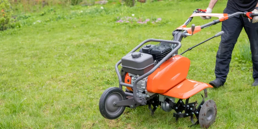 man works the land in the garden with a cultivator