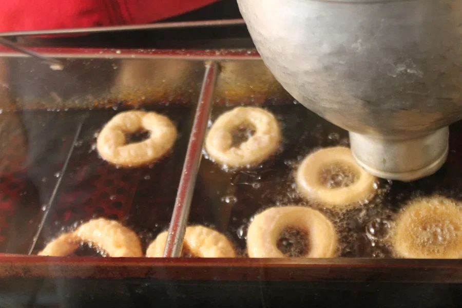 frying donuts in a market