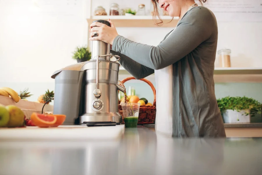 young female bar employee making fruit juice