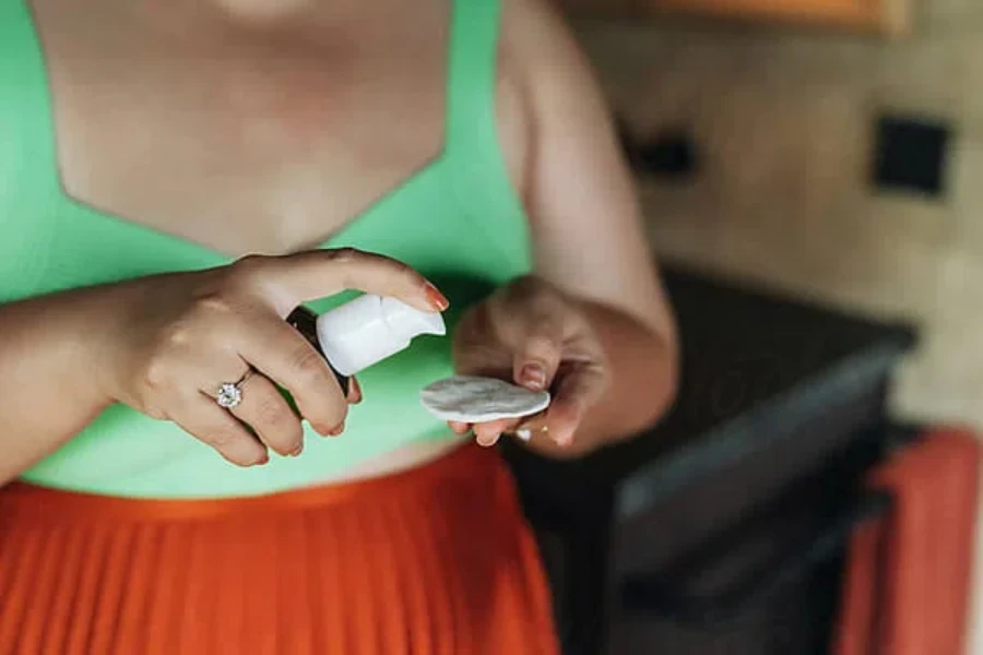 a woman sprays makeup remover