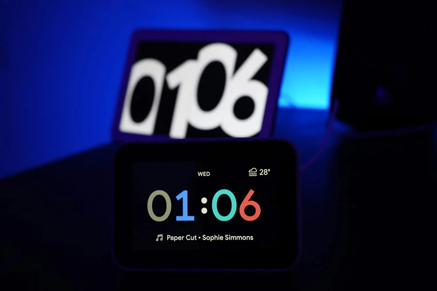 lenovo smart clock with google assistant in front of Google Home Hub