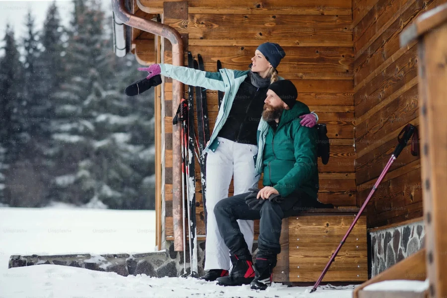 Man and woman preparing to ski