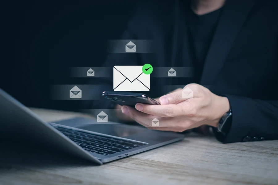 man looking at mobile with email notification