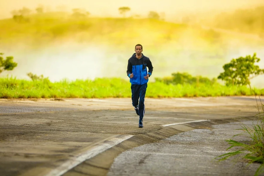 Man running along road with yellow haze behind him