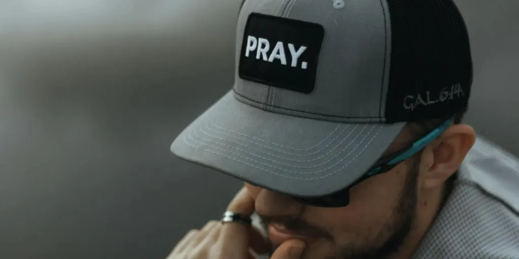 Man wearing a black and gray trucker hat