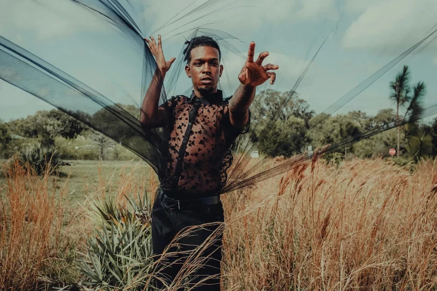 man wearing a black see-through shirt