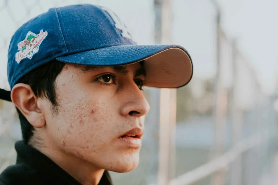 Man wearing a blue baseball hat