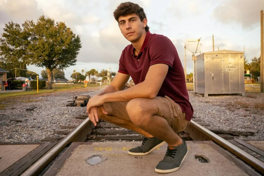 man wearing a burgundy polo shirt