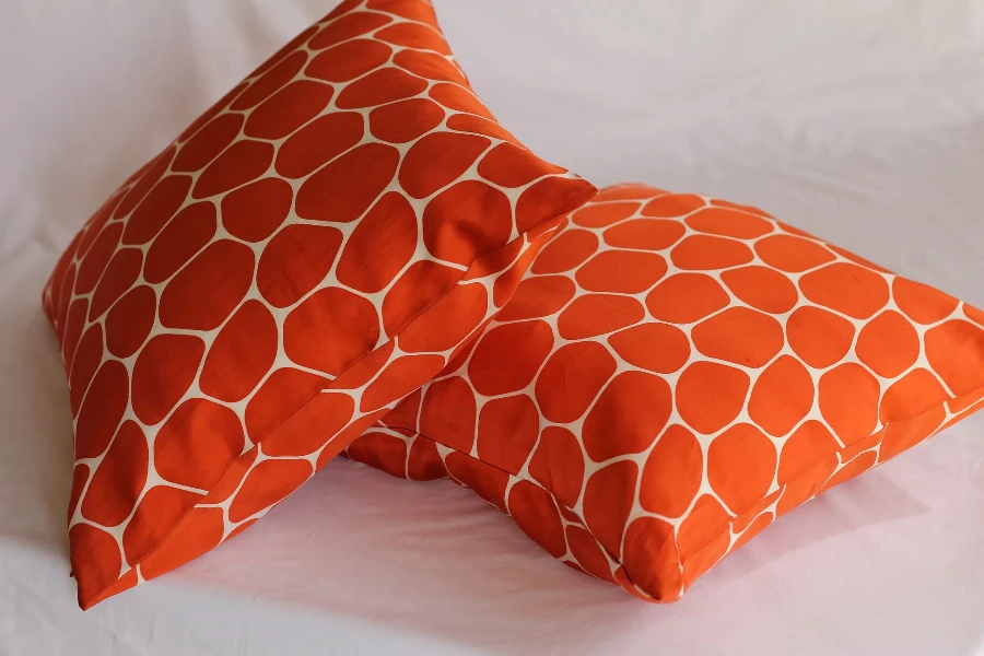 Orange throw pillows on a bed