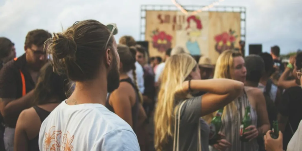 people at a music festival with man in the foreground