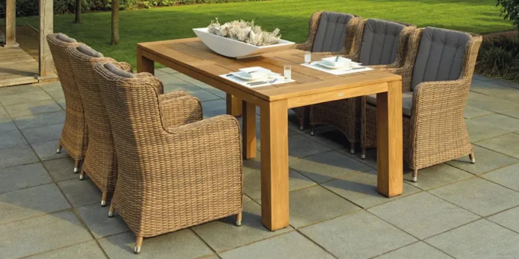 Six rattan patio chairs around a wood table outdoors