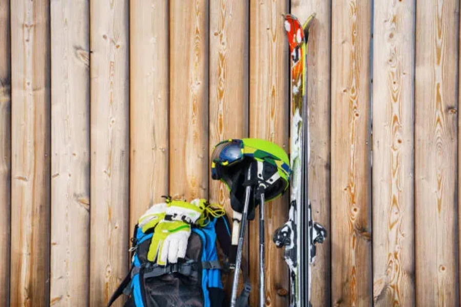 Ski gear and ski boot bag against wooden wall