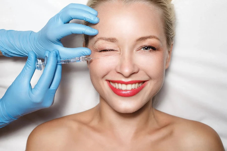 Smiling woman getting a skin booster injection