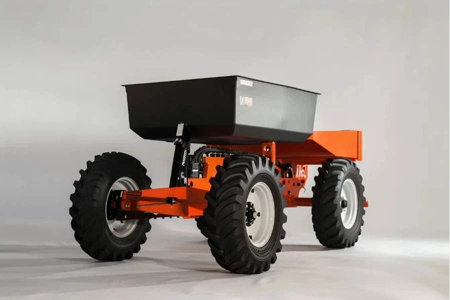 the orange spreader has black and white wheels