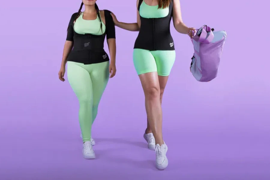 Two ladies wearing waist trimmers