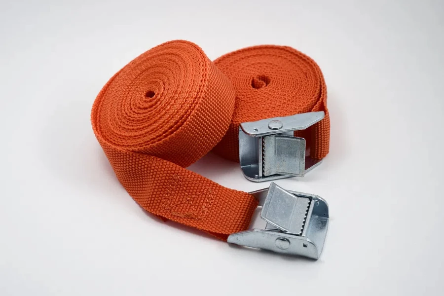 two orange fastening straps on white background