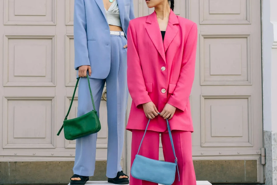 Two women wearing colorful oversized blazer