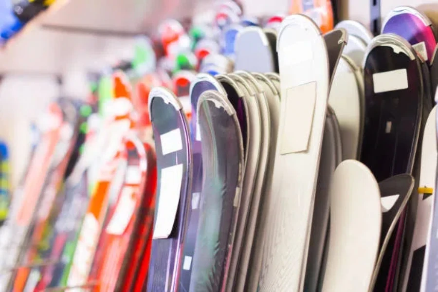 Various colors of skis lined up in shop