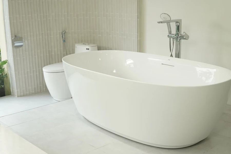 white ceramic bathtub near white window