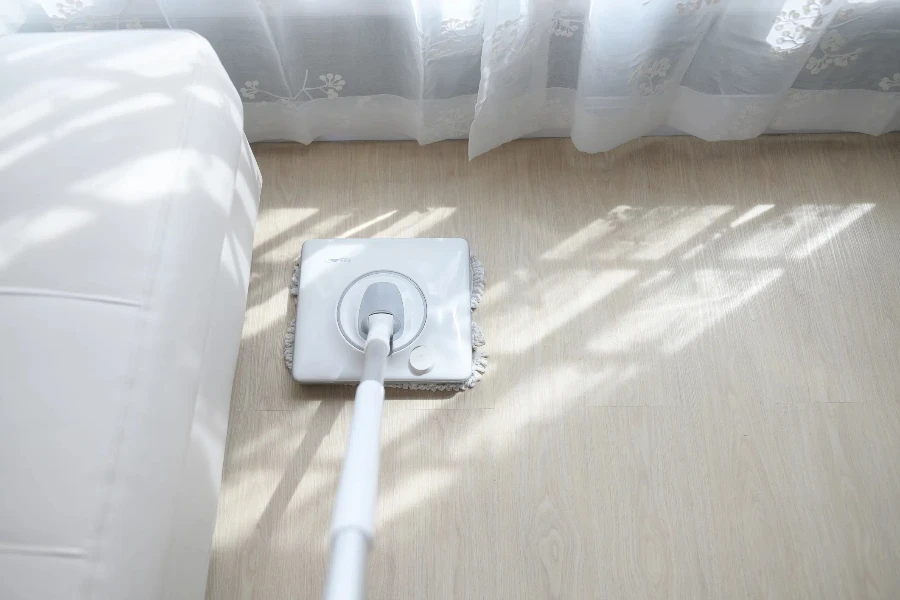White electric spin mop on hardwood floor