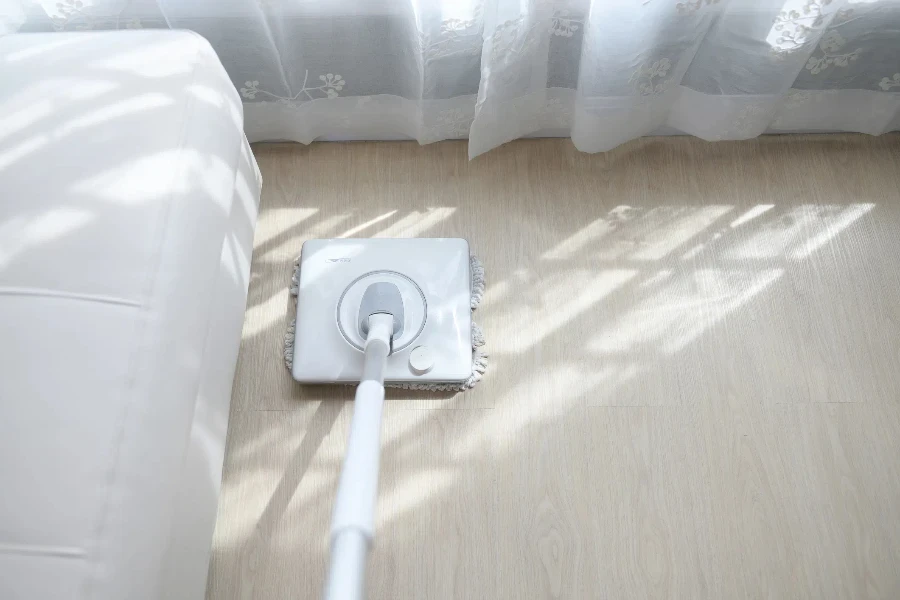 White electric spin mop on hardwood floor