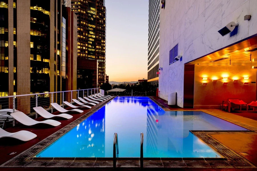 white sun loungers beside swimming pool deck