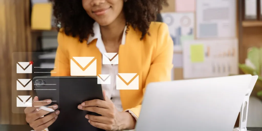 woman checking emails on tablet and laptop