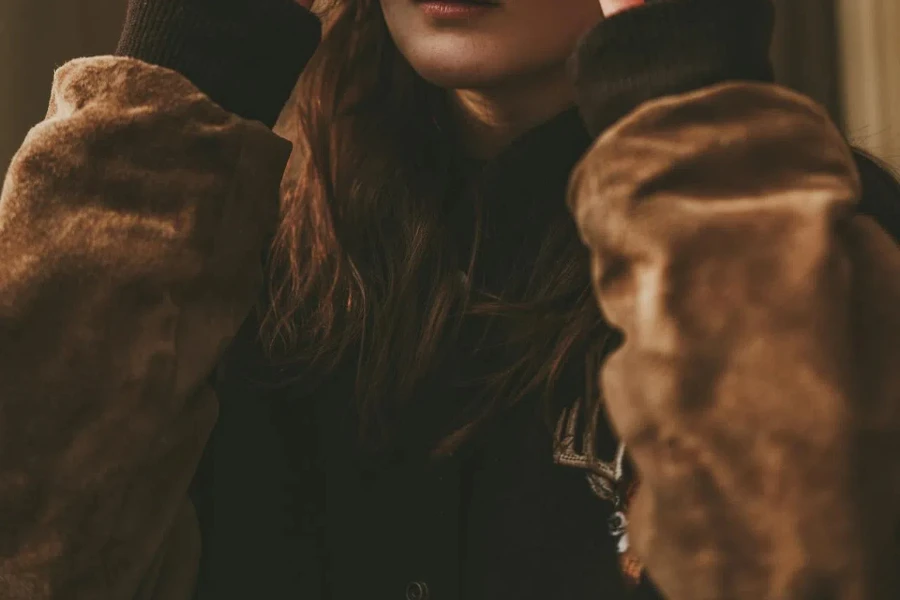 Woman in brown suede bomber jacket