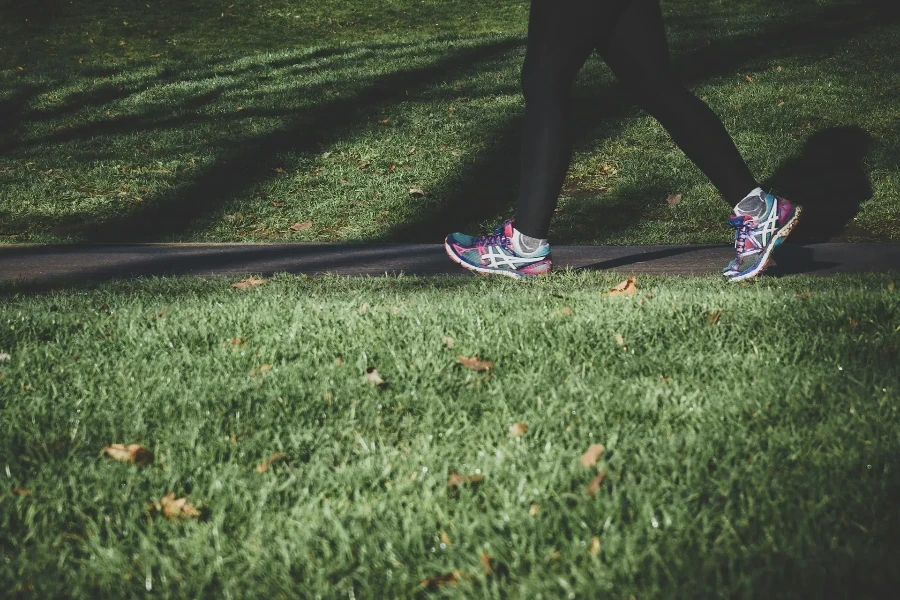 Woman jogging along path in long black leggings