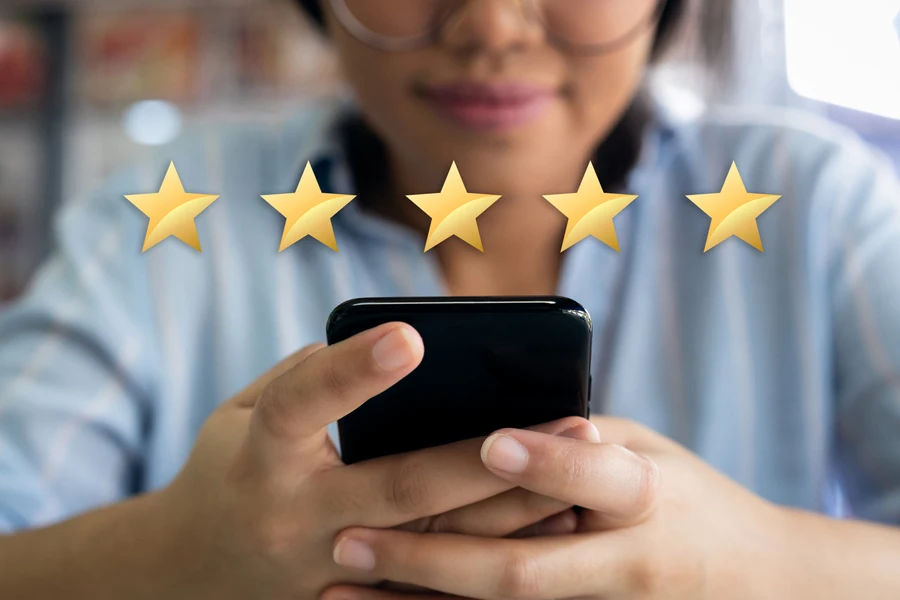 woman using phone giving a 5-star rating