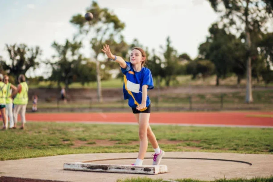 Young girl holding position after throwing shot put