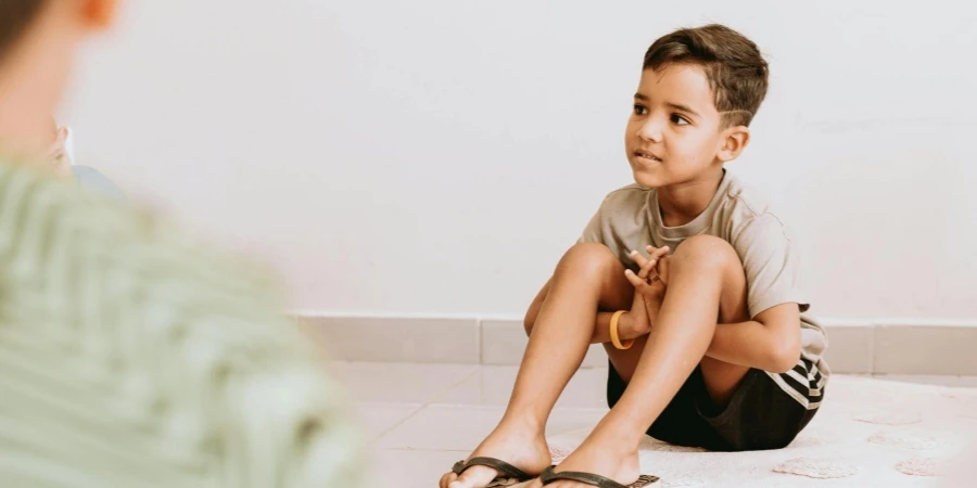 A Boy Sitting on the Floor